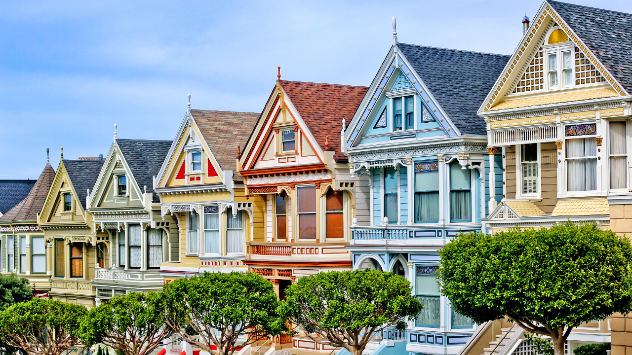A row of ornate Victorian houses in San Francisco, known as the "Painted Ladies," with intricate architectural details and vibrant colors.